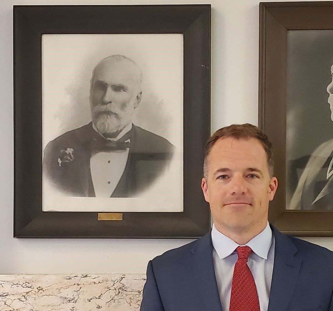 Ole Olson beneath the portrait of his great-great-grandfather, Judge William J. Galbraith